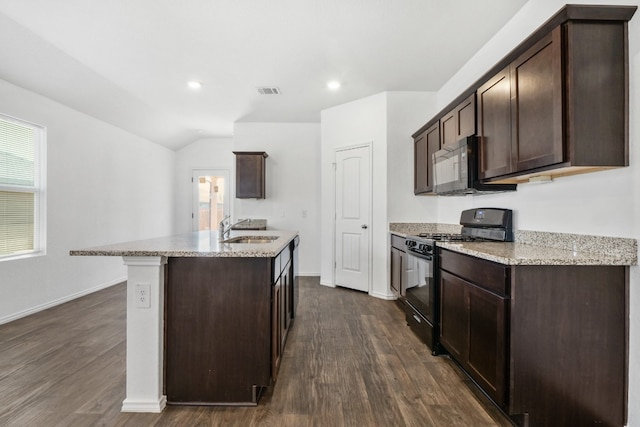 kitchen with dark brown cabinets, black appliances, sink, and dark hardwood / wood-style floors