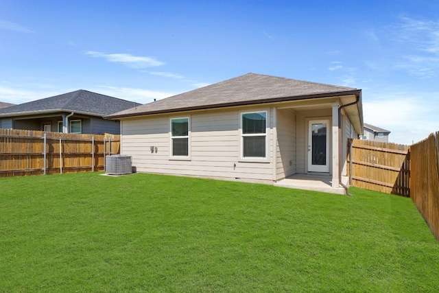 back of property with a yard and a patio