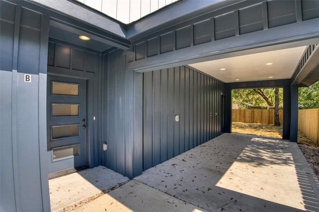 909 Vargas Rd Unit B, Austin, TX 78741 - view of exterior entry featuring fence, a patio area, and board and batten siding