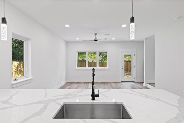 909 Vargas Rd Unit B, Austin, TX 78741 - interior space featuring light wood finished floors, a sink, visible vents, a ceiling fan, and pendant lighting