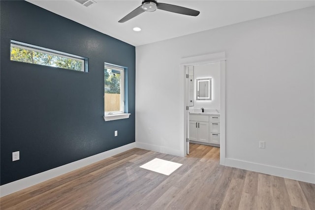 909 Vargas Rd Unit B, Austin, TX 78741 - unfurnished bedroom with recessed lighting, baseboards, ensuite bath, and light wood-style flooring