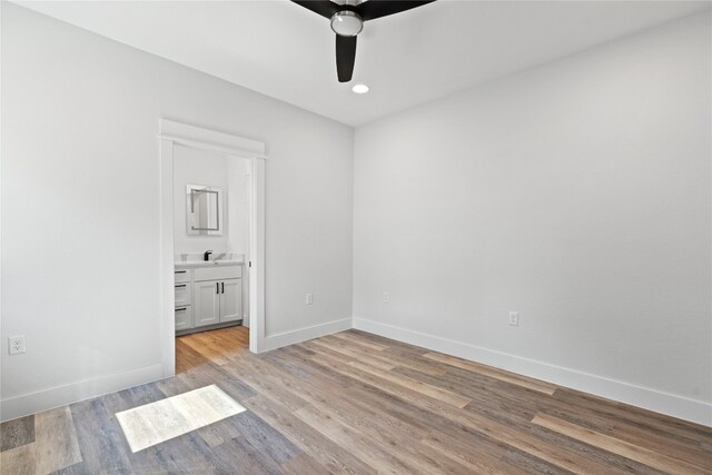 unfurnished room featuring ceiling fan, sink, and light hardwood / wood-style floors