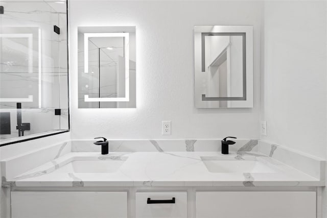 909 Vargas Rd Unit B, Austin, TX 78741 - full bath with a marble finish shower, a sink, and double vanity