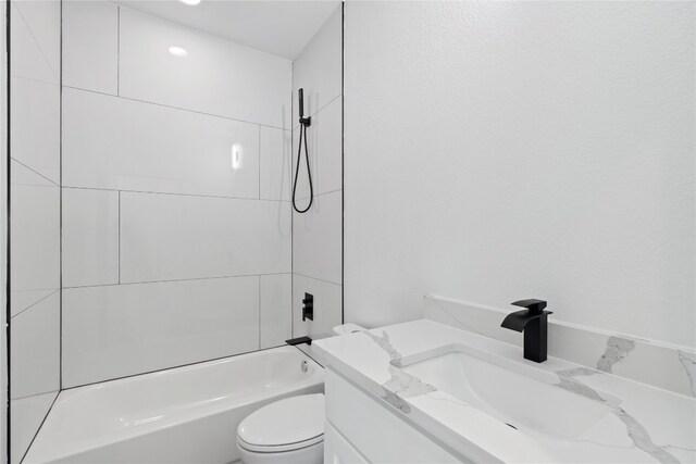 full bathroom featuring vanity, toilet, and tiled shower / bath