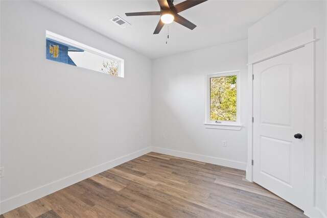 empty room with light wood-type flooring and ceiling fan