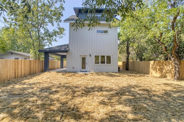 909 Vargas Rd Unit B, Austin, TX 78741 - back of house featuring board and batten siding and a fenced backyard