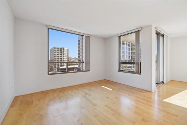 unfurnished room with light wood-type flooring