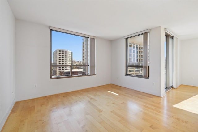 unfurnished room with wood finished floors