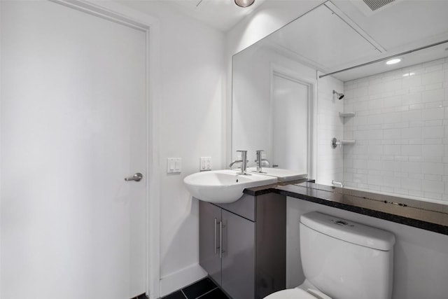 bathroom featuring vanity, tile patterned flooring, visible vents, a shower, and toilet