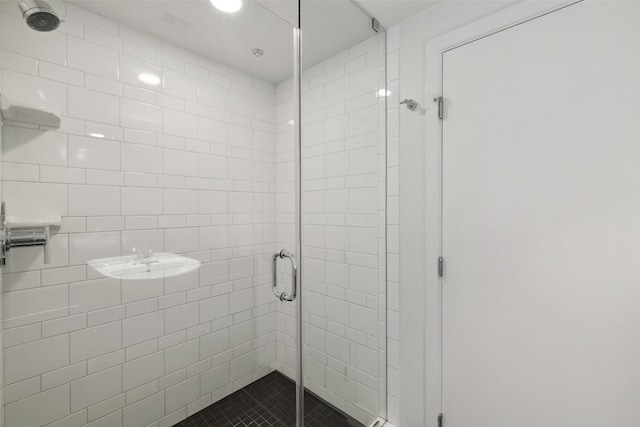 bathroom featuring a shower with door