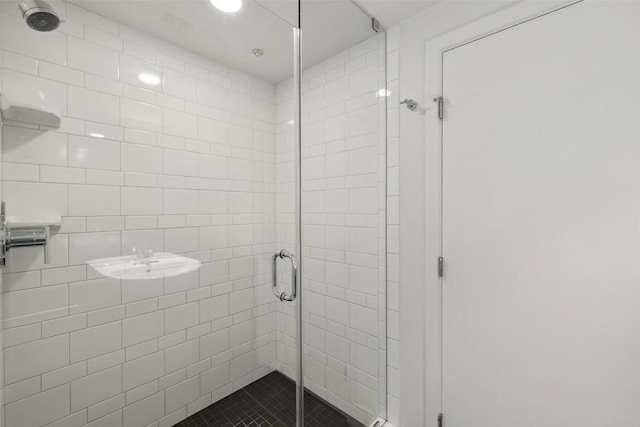 bathroom featuring recessed lighting and a shower stall