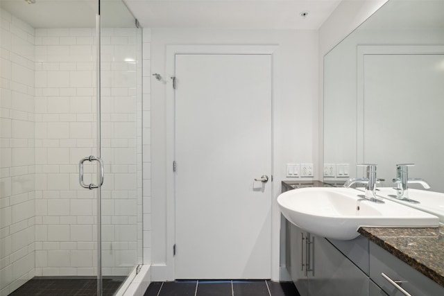 bathroom with vanity, a shower with shower door, and tile patterned floors