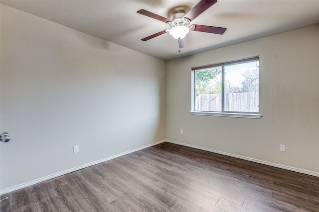 unfurnished room featuring dark hardwood / wood-style floors and ceiling fan