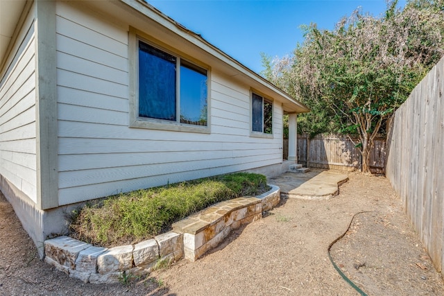 view of side of home with a patio area