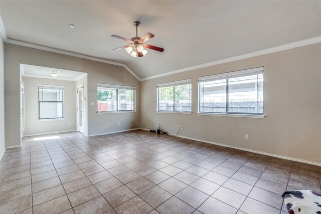 tiled empty room featuring ceiling fan, lofted ceiling, and crown molding