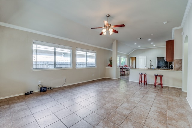 unfurnished living room with light tile patterned flooring, crown molding, ceiling fan, and vaulted ceiling