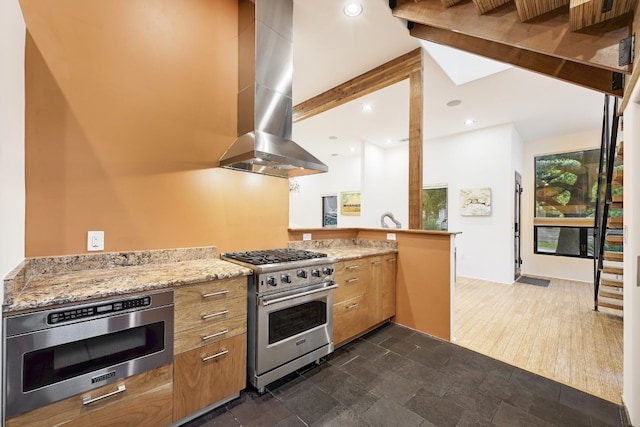 kitchen with dark wood-type flooring, extractor fan, kitchen peninsula, appliances with stainless steel finishes, and beam ceiling