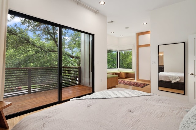 bedroom featuring light wood-type flooring and access to outside