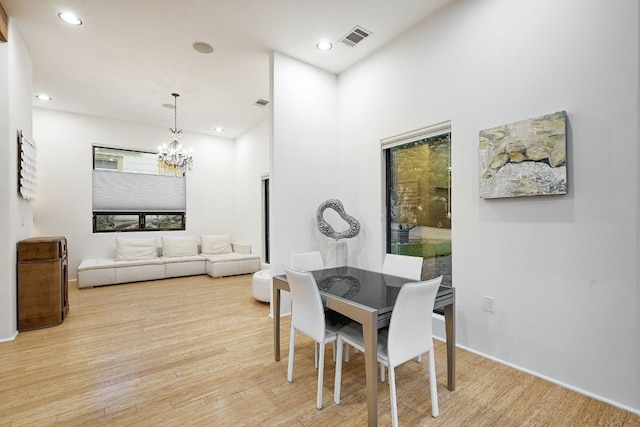 dining room featuring a notable chandelier and light hardwood / wood-style floors