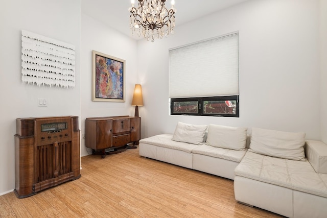 living room featuring light wood-type flooring and an inviting chandelier