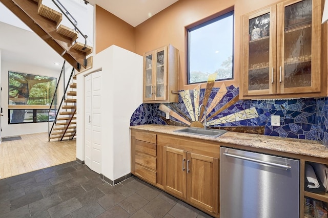 kitchen featuring sink, plenty of natural light, stainless steel dishwasher, and dark hardwood / wood-style flooring