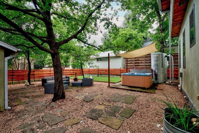 view of yard with outdoor lounge area, a patio area, and a hot tub