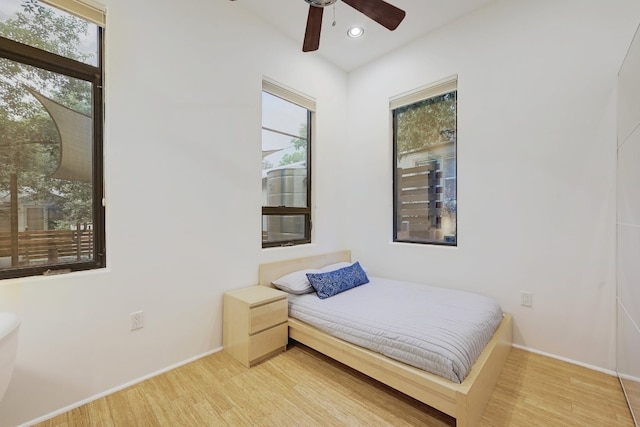 bedroom with hardwood / wood-style flooring and ceiling fan