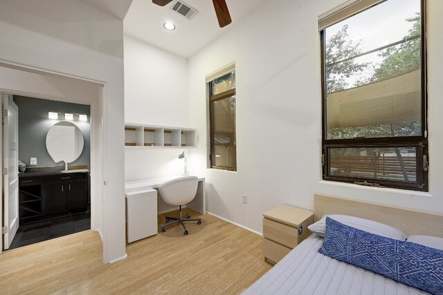 bedroom featuring ensuite bathroom, sink, ceiling fan, and hardwood / wood-style floors