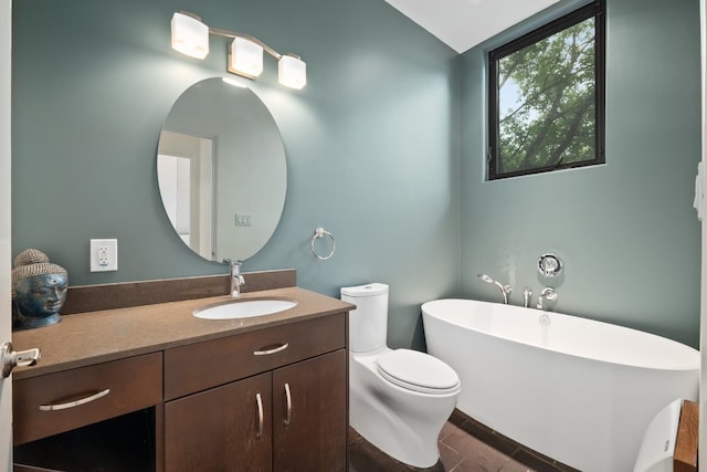 bathroom featuring hardwood / wood-style floors, vanity, a bath, vaulted ceiling, and toilet