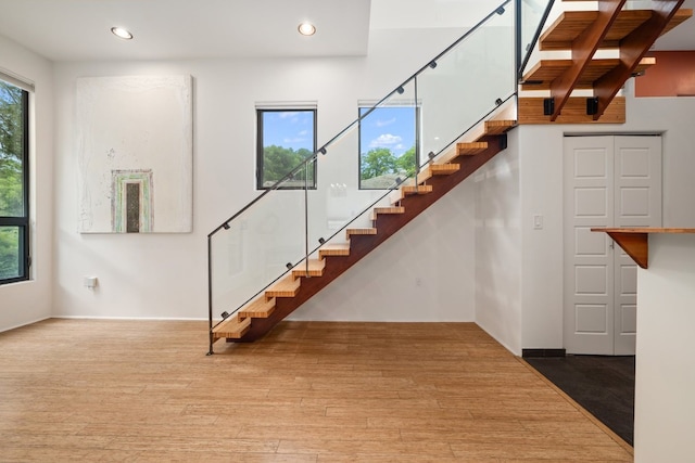 staircase with hardwood / wood-style flooring