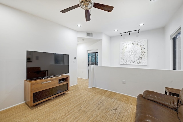 living room featuring ceiling fan, light hardwood / wood-style floors, and rail lighting