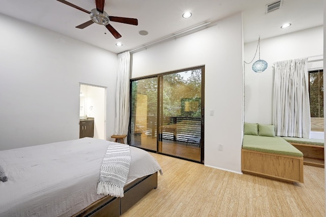 bedroom with light wood-type flooring, ceiling fan, ensuite bathroom, and access to outside