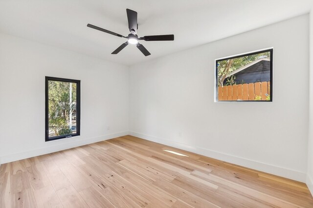 unfurnished room featuring ceiling fan, light hardwood / wood-style flooring, and plenty of natural light