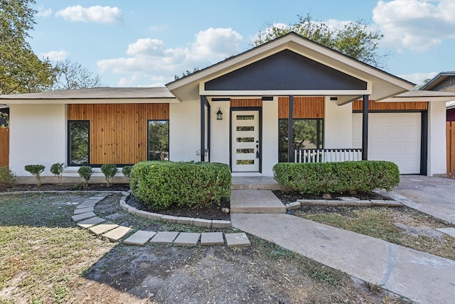 view of front of property featuring covered porch and a garage