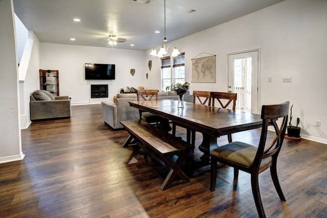 dining space with dark hardwood / wood-style floors and a chandelier