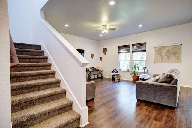 living room featuring dark hardwood / wood-style flooring and ceiling fan