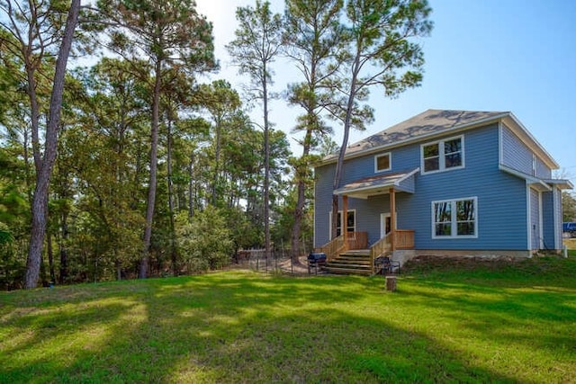 rear view of house with a lawn