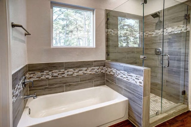 bathroom featuring independent shower and bath and hardwood / wood-style flooring