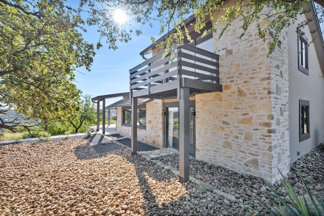 exterior space featuring a balcony and a patio area