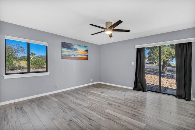 spare room with ceiling fan and light wood-type flooring