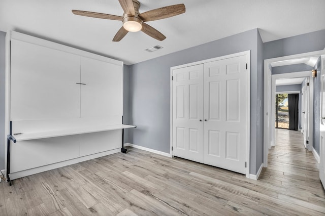 unfurnished bedroom with a closet, ceiling fan, and light hardwood / wood-style floors