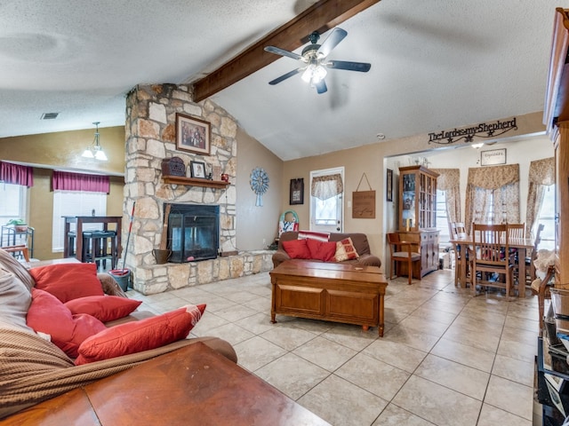 tiled living room featuring a fireplace, ceiling fan, vaulted ceiling with beams, and a textured ceiling