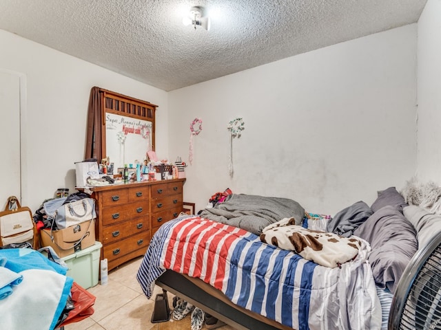 tiled bedroom with a textured ceiling