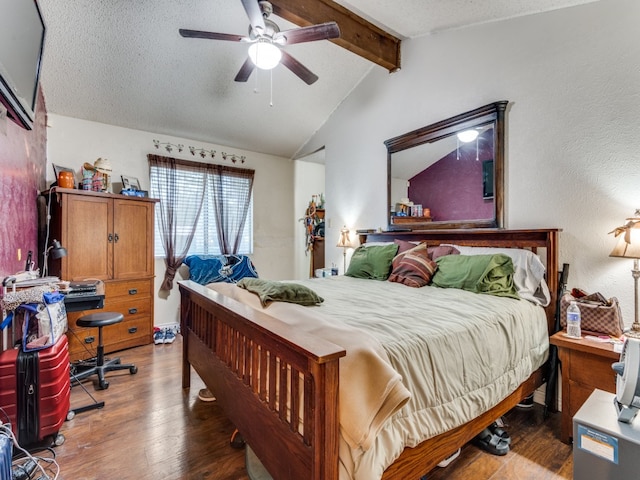 bedroom with lofted ceiling with beams, ceiling fan, dark wood-type flooring, and a textured ceiling