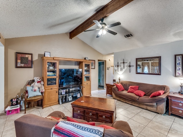 living room featuring ceiling fan, vaulted ceiling with beams, light tile patterned floors, and a textured ceiling