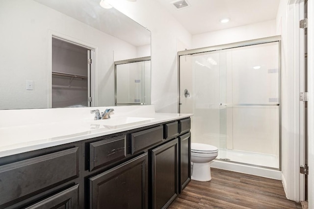 bathroom featuring a stall shower, visible vents, wood finished floors, and vanity