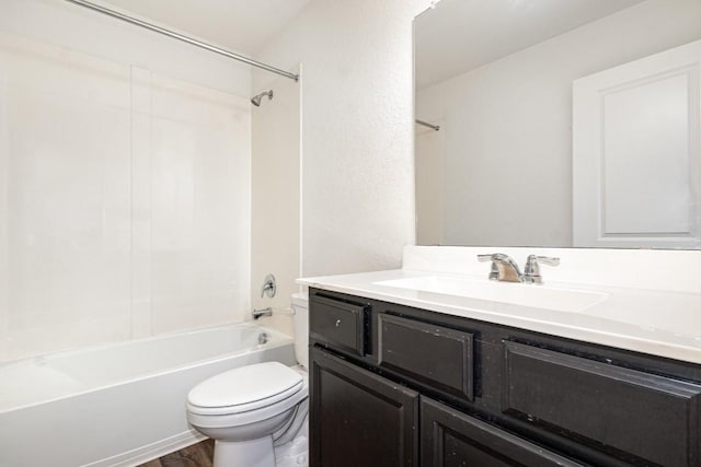 bathroom with toilet, tub / shower combination, wood finished floors, and vanity