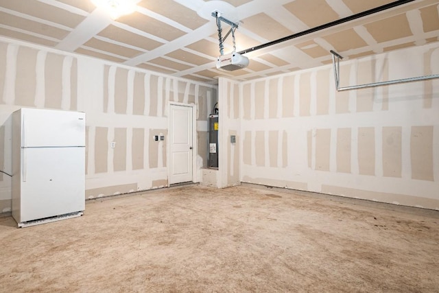 garage with electric water heater, freestanding refrigerator, and a garage door opener