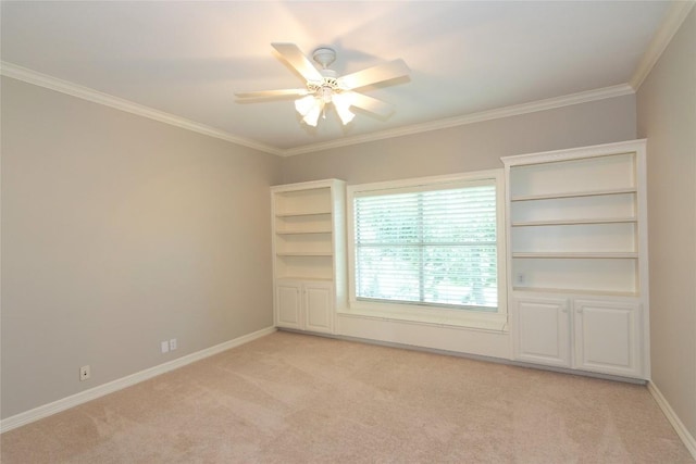 spare room with baseboards, crown molding, and light colored carpet