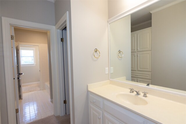 bathroom with ornamental molding, tile patterned floors, and vanity